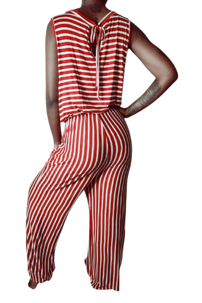 Person wearing a red and white striped jumpsuit on a white background